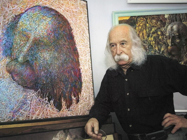 Image -- Ivan Marchuk with his paintings.