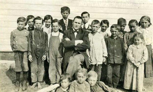 Image -- A school teacher and his pupils in Poltawa School district in Cudworth, Saskatchewan (photo, courtesy of the Ukrainian Museum of Canada, Saskatoon Branch).