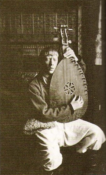 Image -- Vladimir Tatlin performing as a blind bandura player (Berlin, 1914).