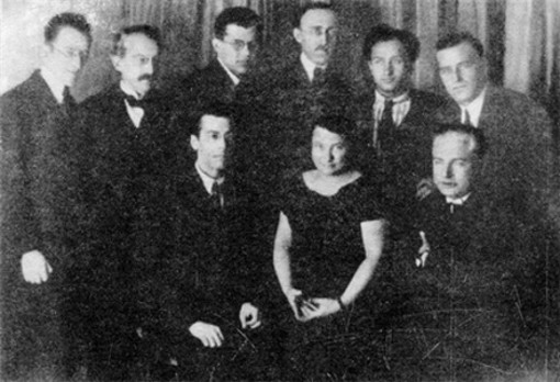 Image -- Pavlo Tychyna (sitting, far left) among Ukrainian and Czech writers in Prague, 1925.