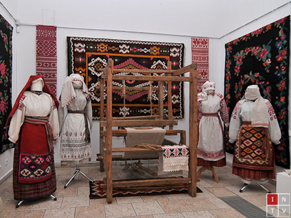 Image -- A traditional weaver's loom and folk dresses from Podilia.